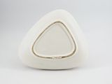 a white triangle shaped object on a white surface