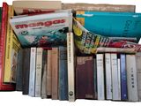 a lot of books that are stacked on top of each other