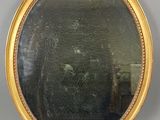 un miroir rond avec un cadre doré accroché au mur