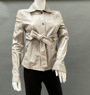 a mannequin wearing a beige jacket and black pants