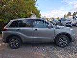 a picture of a silver suv parked in a parking lot