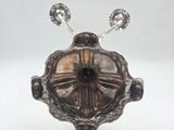 an image of a silver plate with two spoons on top of it