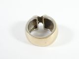 sterling silver ring with a black stone in it on a white surface