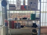 a metal shelf with various items on it in a room