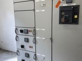 an electrical panel in a room with a lot of electrical equipment