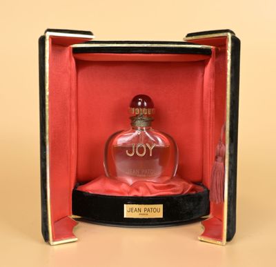 an open box with a perfume bottle inside of it on a table