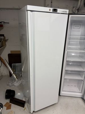 a white refrigerator and a freezer in a room