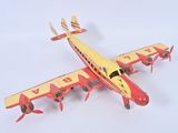underside view of a red and yellow model of a plane on a white surface