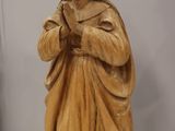 carved wooden statue of a woman holding a baby
