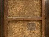 an old picture of a wooden frame with a picture on it
