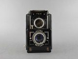 an old black camera with a lens on a white background