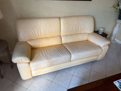 a white couch sitting in a living room next to a table