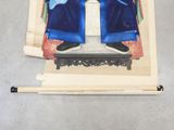 a figurine of a man sitting on top of a table