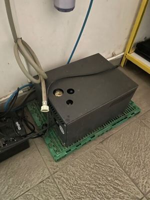 a video game system sitting on the floor next to a remote control