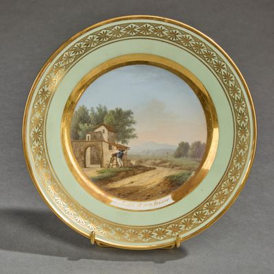 a plate with a painting on it on a table