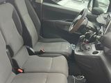 the interior of a small car with two seats and a steering wheel