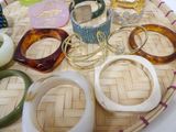 many different colored bracelets on a tray on a table