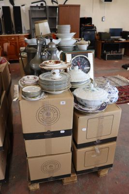 a pile of plates and bowls on a carton in a room