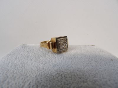 a close up of a gold ring with diamonds on a white surface