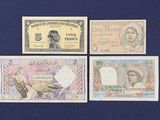 four different bank notes are shown on a blue surface