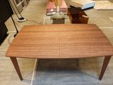 a wooden table with a glass top in a room