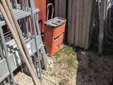a pile of chairs and shovels in front of a building