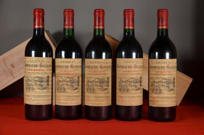 four bottles of wine are lined up on a table