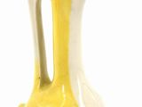 a yellow and white vase with a blue beak on it