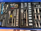 many tools in a blue tool box on a table
