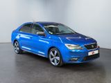 a blue car is parked in a room with a white wall