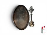 a spoon and a spoon rest on a white surface