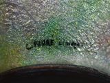 a close up view of a green vase with a black base