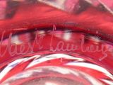 a close up of a glass with a candy cane inside of it