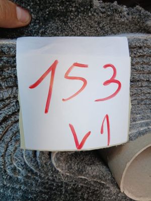 a person holding a piece of paper with a number on it