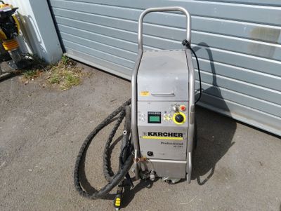 an image of a machine that is on the ground near a garage