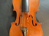 an old violin sitting on top of a table next to a wall