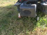 a lawn mower that is sitting in the grass