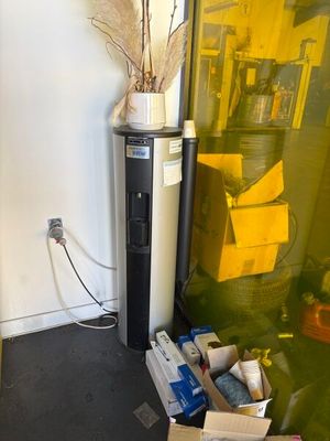 a refrigerator and a refrigerator freezer in the corner of a room