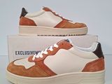 men ' s white and tan sneakers with brown trims on top of a box