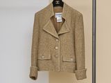 the coat is hanging on a clothes rack in the room