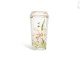 a vase with a flower inside of it on a white surface