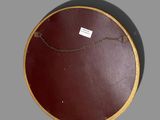 a brown circular object with a chain hanging from it