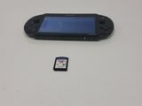 a game console and a card sitting on a table