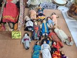 a table with a lot of dolls and other items on it