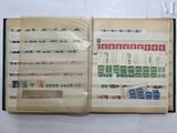 an open book with stamps on it sitting on a table