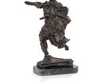 an image of a bronze statue of a man with a sword