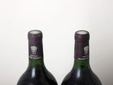 two bottles of wine that are sitting on a table