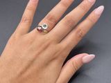 a woman ' s hand with a ring on it