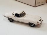 a toy car sitting on the floor next to a refrigerator