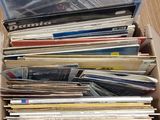 a box full of vinyl records sitting on a table